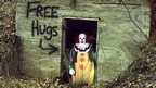 Clown in the woods offering free hugs