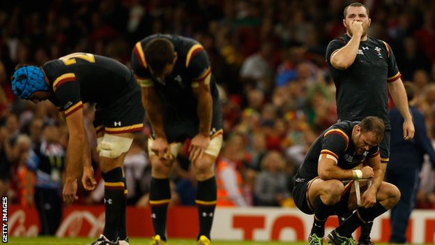 Wales players slumped in relief and fatigue after the final whistle against Fiji