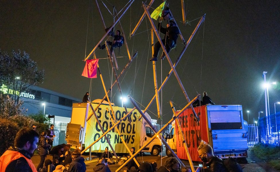 Extinction Rebellion activists block the entrance to Newsprinters facility in Broxbourne, Hertfordshire