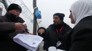 Border guards check a woman's papers at Idomeni (12 Jan)