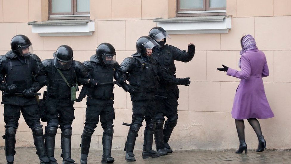 A woman argues as Belarus police block a street