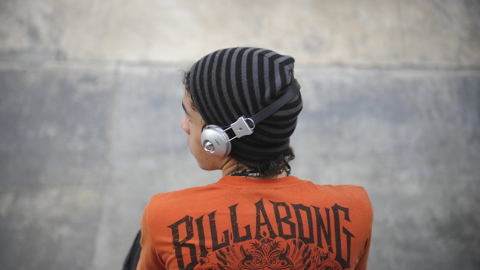 Skateboarder listens to music through headphones in Carracas, 2011