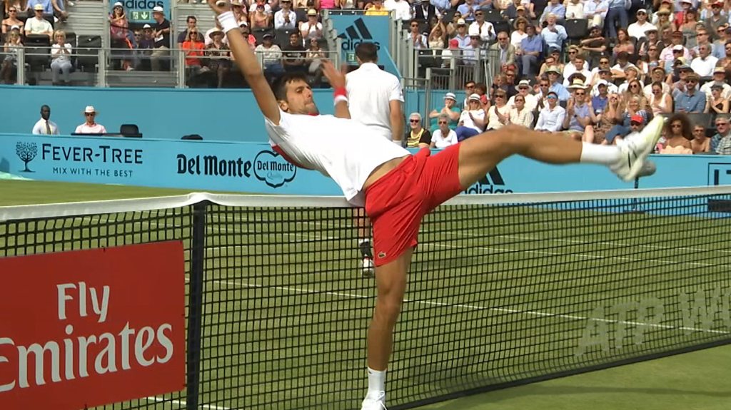 Unhappy Novak Djokovic loses point for touching the net