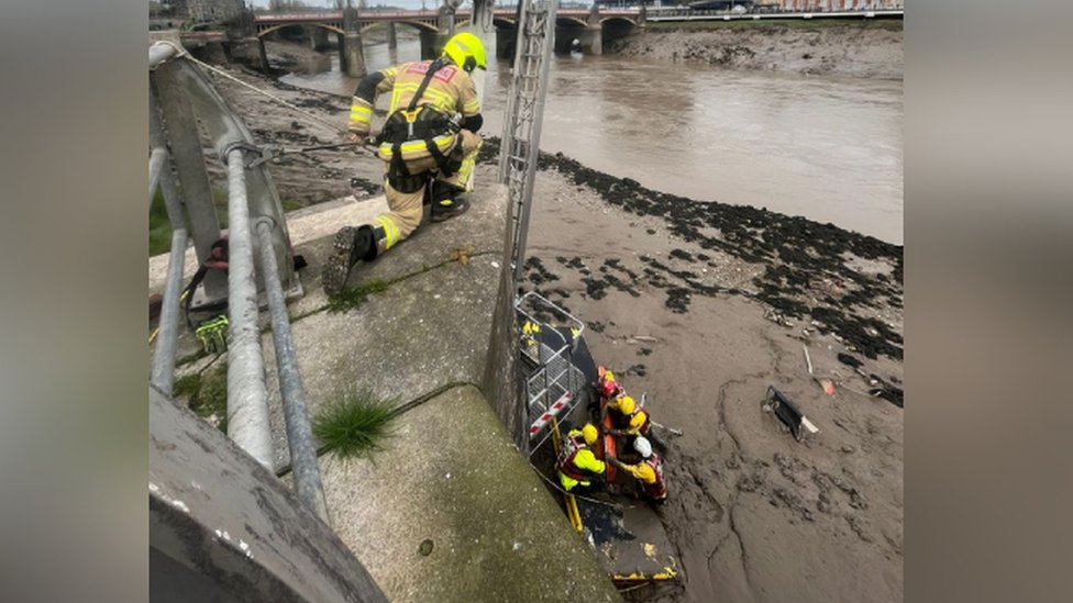 Person is rescued from mud on river bank