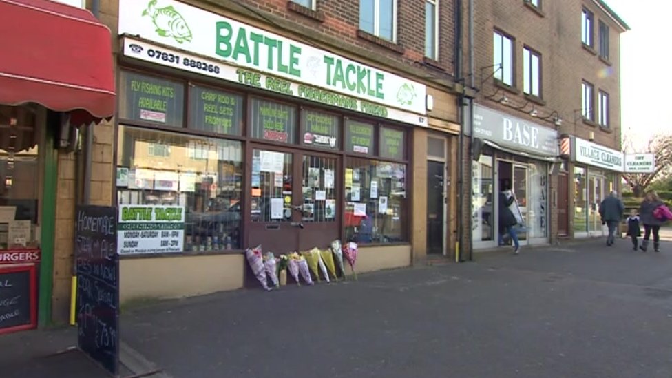 Flowers laid outside the angling shop run by Carrie Izzard