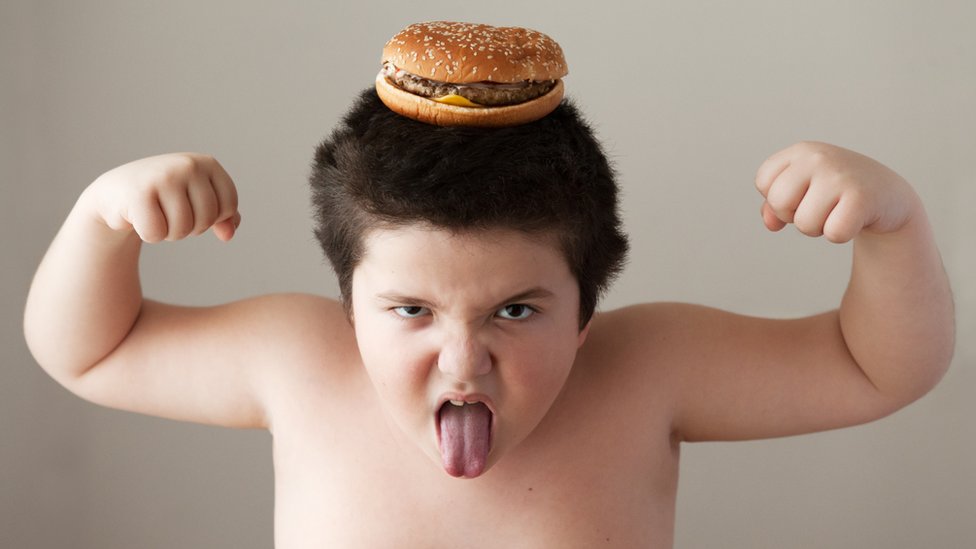 Boy with burger on his head