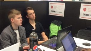 Elliot and one of his teammates having to resolve issues in their code