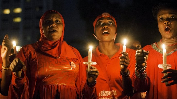 People hold candles during a vigil for the girls who were abducted from a secondary school in Chibok, on the anniversary of their abduction in Abuja 14 April 2015