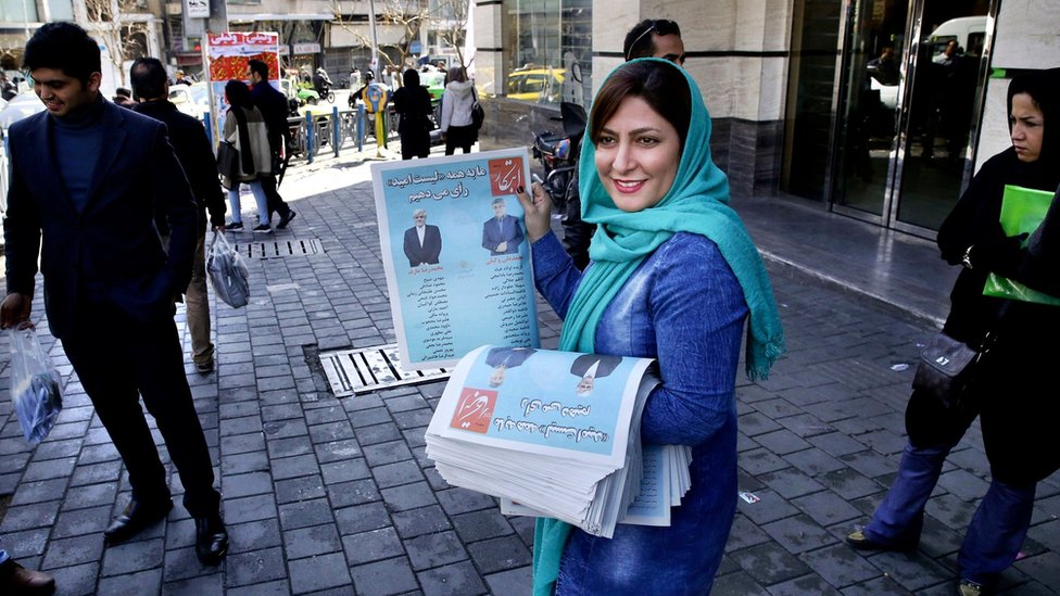 A campaign worker distributes electoral leaflets of reformist candidates in Tehran, Iran (24 February 2016)