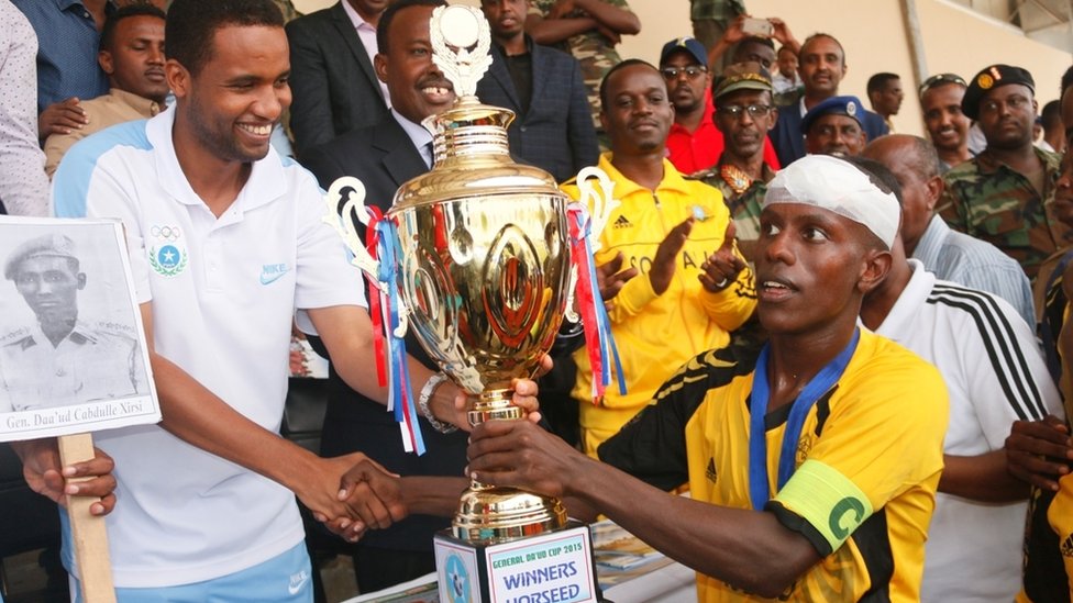 Horseed captain being given the cup