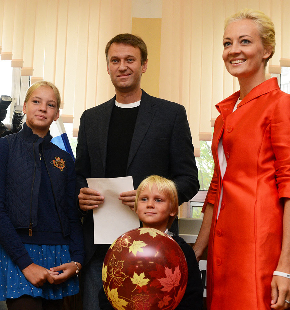 Alexei Navalny holds his ballot at a polling station with his family during the mayoral election in Moscow - 8 September 2013