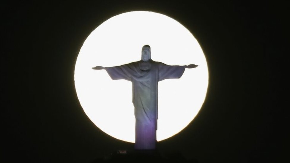 The Supermoon shines behind the Christ the Redeemer statue in Rio de Janeiro, Brazil. Photo: 26 May 2021