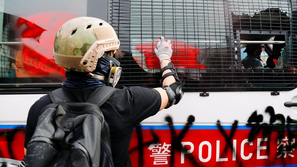 A demonstrator paints on a police vehicle during a protest against the Yuen Long attacks in Yuen Long, New Territories, Hong Kong, China July 27, 2019