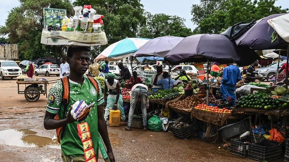 A man walks through a market in Niamey