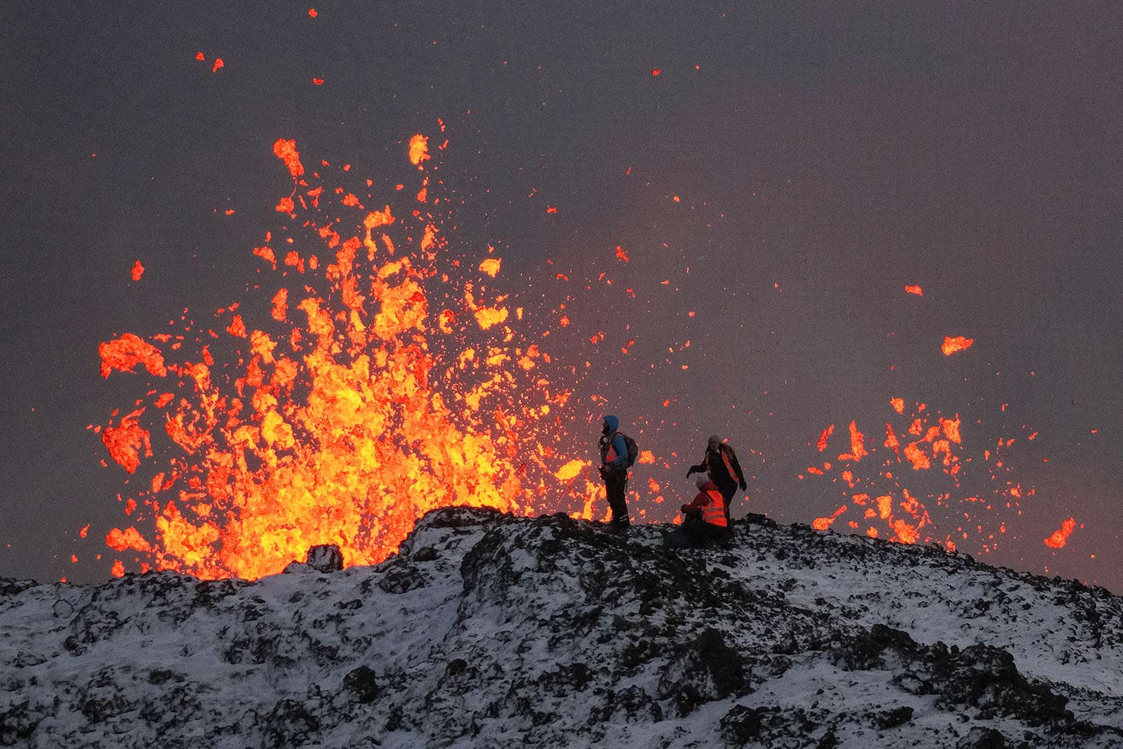 A team of scientists works on the ridge of a volcanic fissure near the town of Grindavik - 19 December 2023