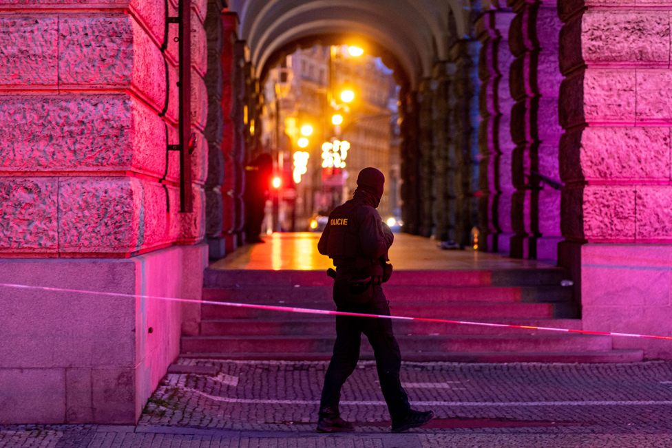 A police officer patrols following a mass shooting at one building of the Charles University in central Prague, Czech Republic, 22 December 2023.