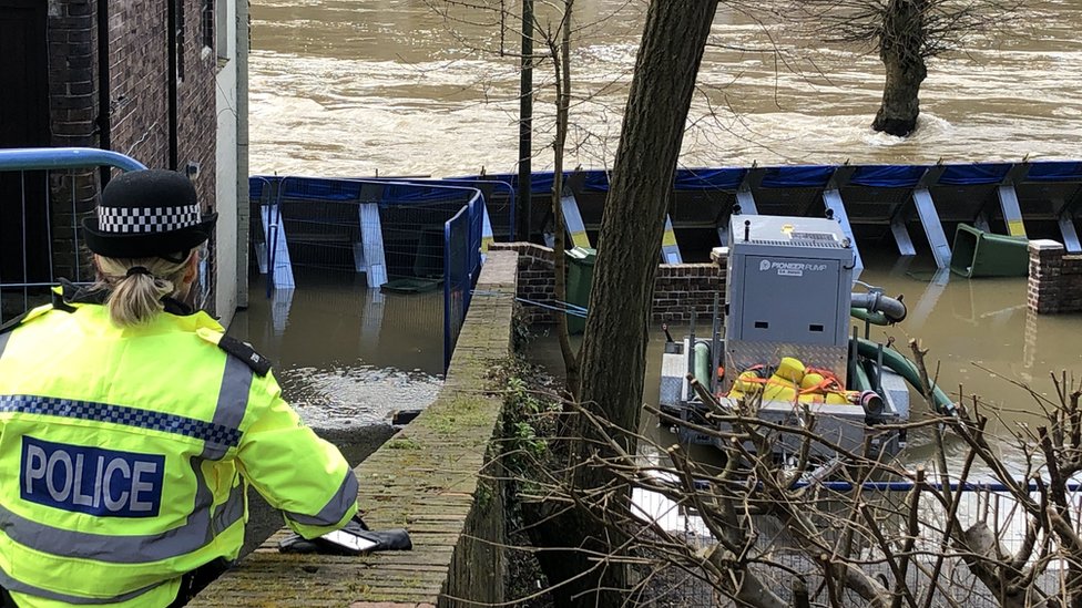 Временные барьеры от наводнений, которые были перенесены рекой Северн в сторону пристани в Айронбридже, Шропшир.