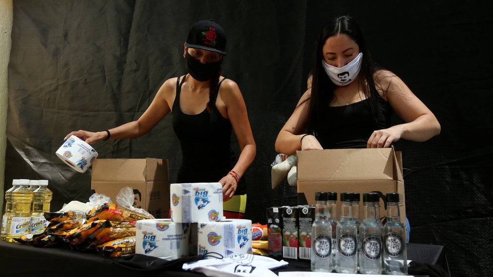 Employees of the clothing brand owned by El Chapo`s daughter box up food supplies