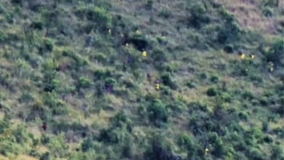 An image shared by the Ugandan army showing escaped prisoners in yellow uniforms. It was captioned by a spokesperson as follows: "The operation by UPDF in pursuit of escapees from Singila prison in Moroto to rearrest them and recover the stolen guns continues."