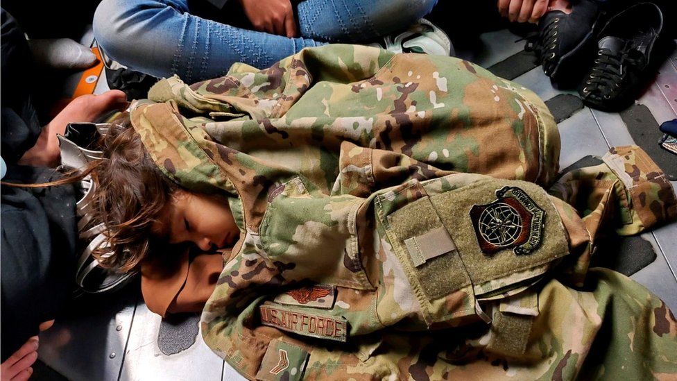 Afghan child in sleeps on the cargo floor of a US Air Force C-17 Globemaster III