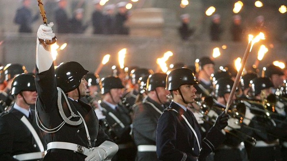 Members of the German armed forces, the Bundeswehr, carry torches in a ceremony called the "grosser Zapfenstreichen" in 2005