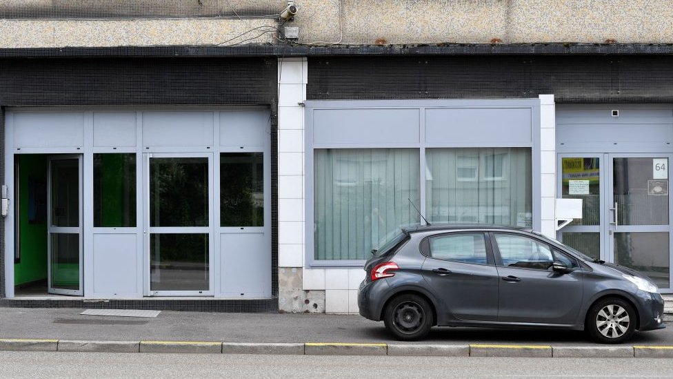 A photograph shows the entrance door of the building where lived a couple in Forbach, eastern France, on August 7, 2023, after French police said they had arrested a 55-year-old German national who is accused of holding his 53-year-old wife captive in a flat since 2011.