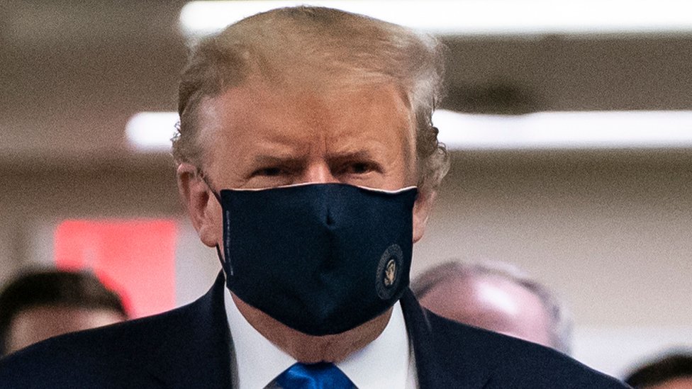 Президент США Дональд Трамп, показанный в Национальном военно-медицинском центре имени Уолтера Рида в Бетесде, штат Мэриленд, в июле, неохотно надевает маску