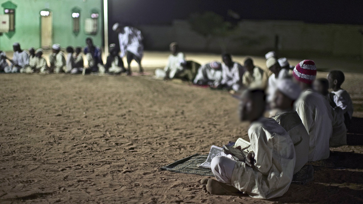 Boys sitting on the ground in the school