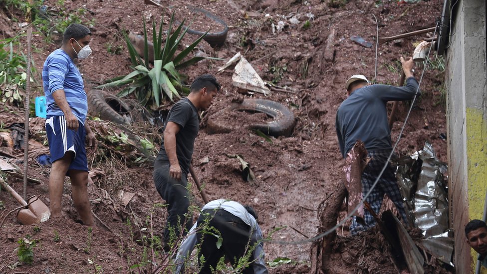 A group of people work to recover belongings from the debris of their homes following a landslide caused by the rains of tropical storm Eta in the city of Tegucigalpa, Honduras, 05 November 2020