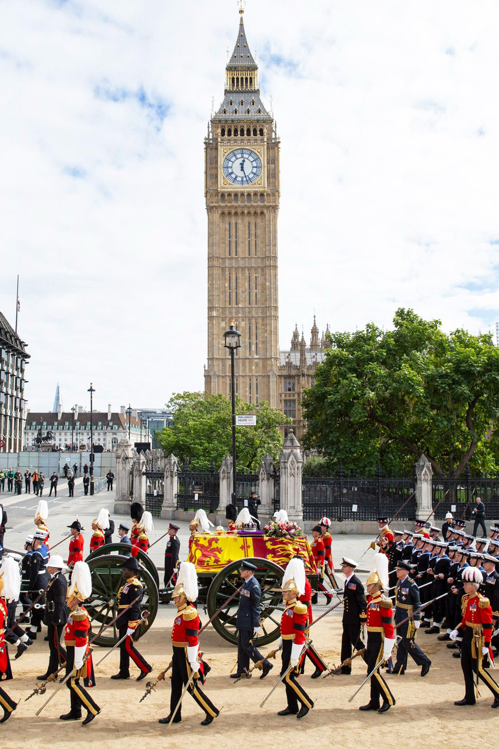 The procession passes the clock tower at the Palace of Westminster.