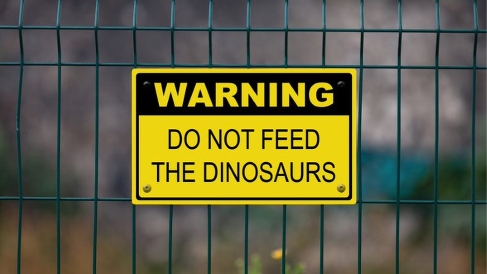 "Do not feed the dinosaurs" sign