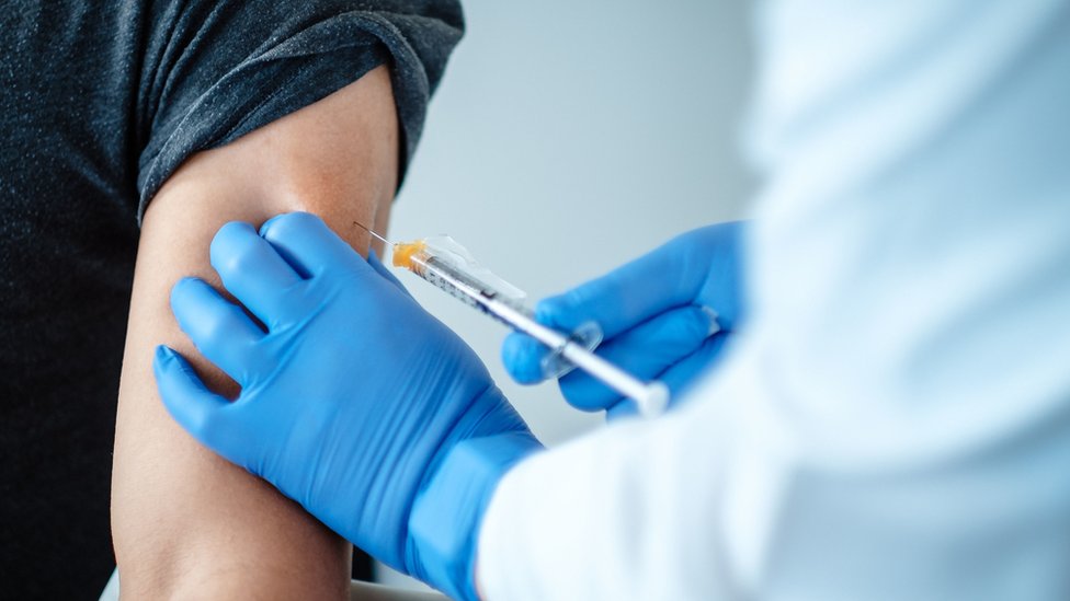 A woman receiving the coronavirus vaccine