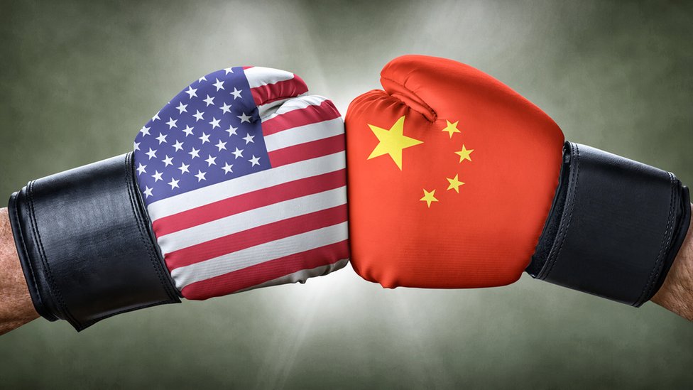 Boxing gloves with the US and Chinese flags clashing