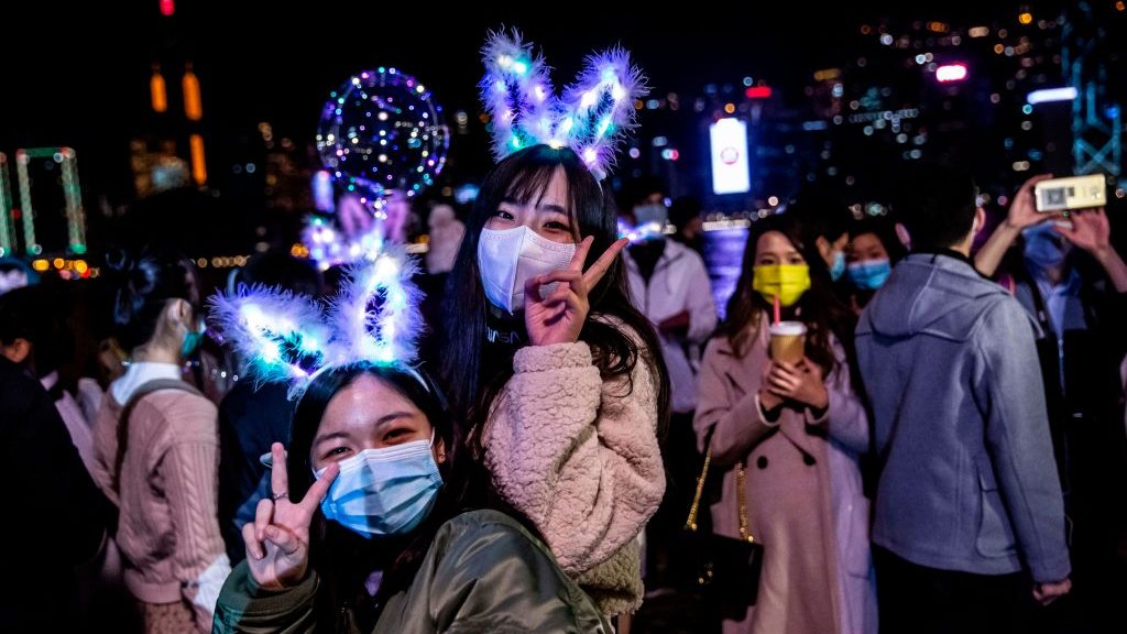 Women celebrate New Year's Eve with light-up bunny ears and festive lights
