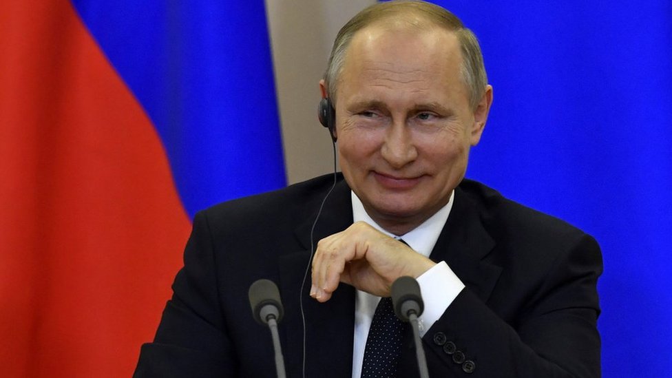 Президент России Владимир Путин улыбается во время совместной пресс-конференции в Сочи, Россия, 17 мая