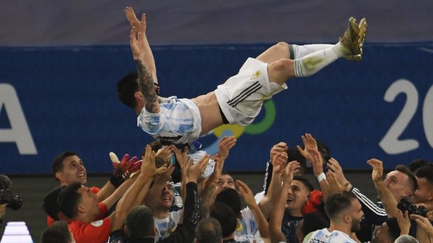 Messi is thrown in the air by his team-mates at full-time