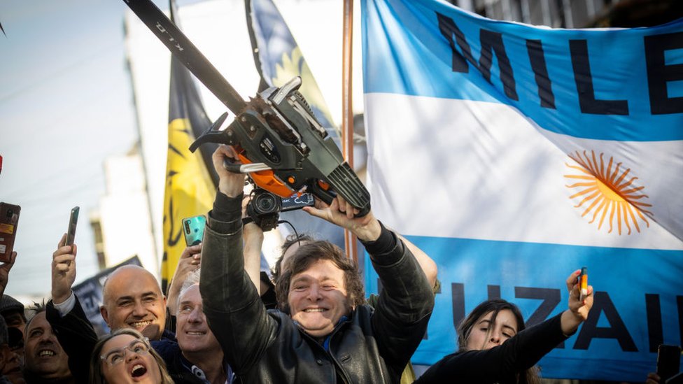 Presidential candidate Javier Milei lifts a chainsaw during a rally in September.