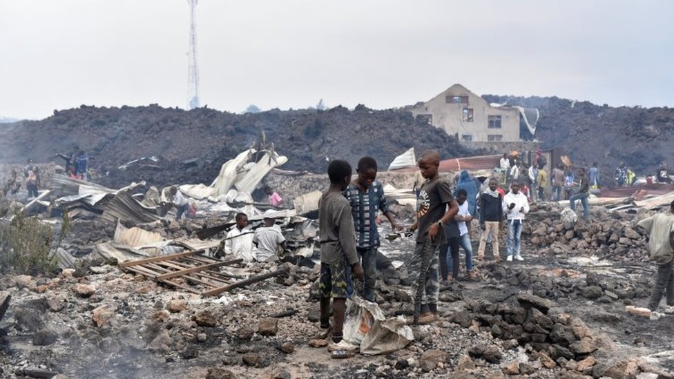 Residents pick up remains of their destroyed homes from the smouldering lava deposited by the eruption of Mount Nyiragongo volcano near Goma, in the Democratic Republic of Congo May 23, 2021