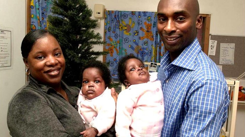 Emma and David Mowatt holding their daughters.