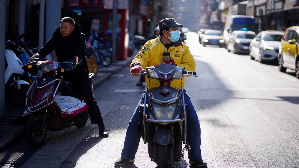 A Meituan delivery worker wearing a face mask is seen on a street following an outbreak of the coronavirus disease (COVID-19) in Shanghai, China January 13, 2021.