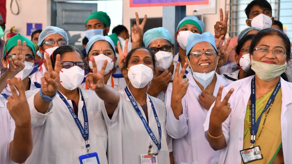 Doctors of the Rajawadi Hospital make the victory sign as they wait for the start of the Covid-19 coronavirus vaccination drive in Mumbai on January 16, 2021.