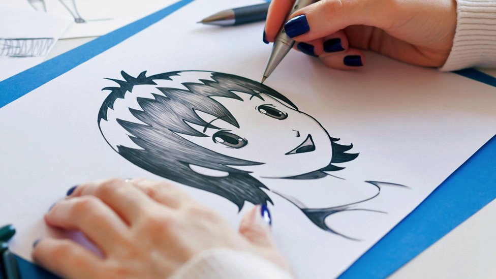 Someone hand-drawing an anime character