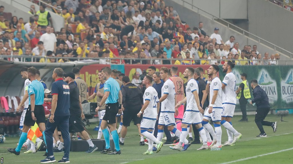 French referee Willy Delajod led the players back to the dressing rooms after suspending the match
