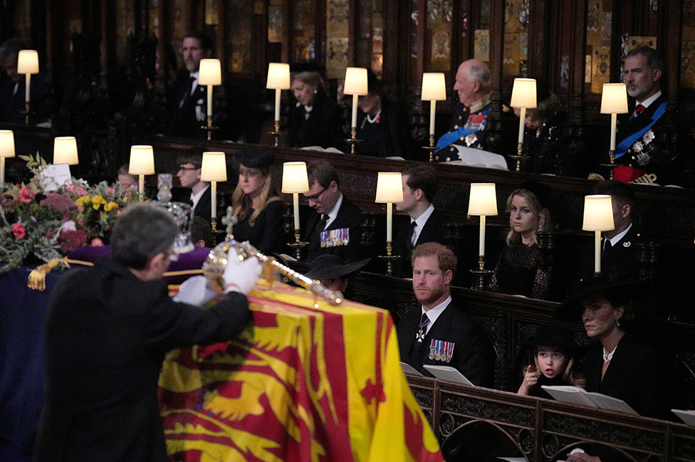 (front row, left to right) The Duke of Sussex, Princess Charlotte, the Princess of Wales, Prince George, watch as the Imperial State Crown and the Sovereign's orb and sceptre are removed from the coffin of Queen Elizabeth II, draped in the Royal Standard, during the Committal Service at St George's Chapel in Windsor Castle, Berkshire