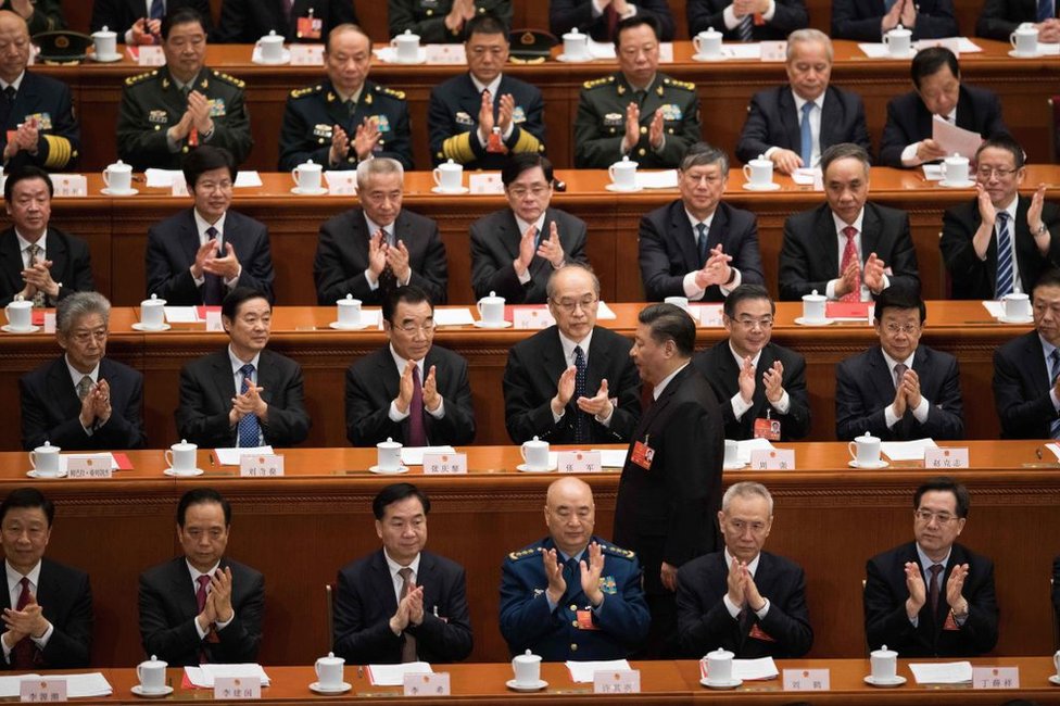 Delegates applaud as China's President Xi Jinping (C) walks past before he delivers a speech during the closing session of the National People's Congress at the Great Hall of the People in Beijing on March 20, 2018.