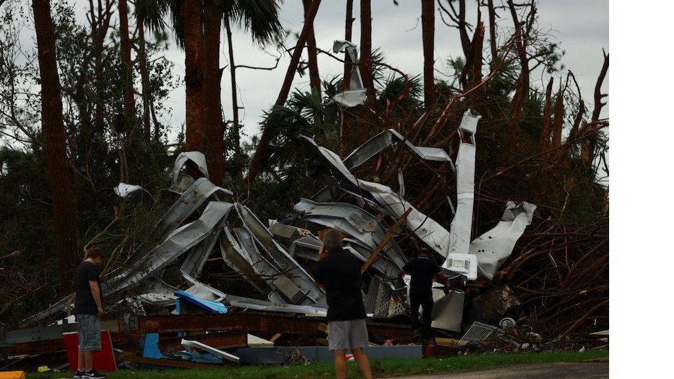 People look at the damage caused by a tornado after Hurricane Milton made landfall, in Lakewood Park, near Fort Pierce, in St. Lucie County, Florida, U.S., October 10, 2024. REUTERS/Jose Luis Gonzalez