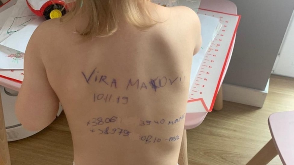 Image shows Vira's back with message