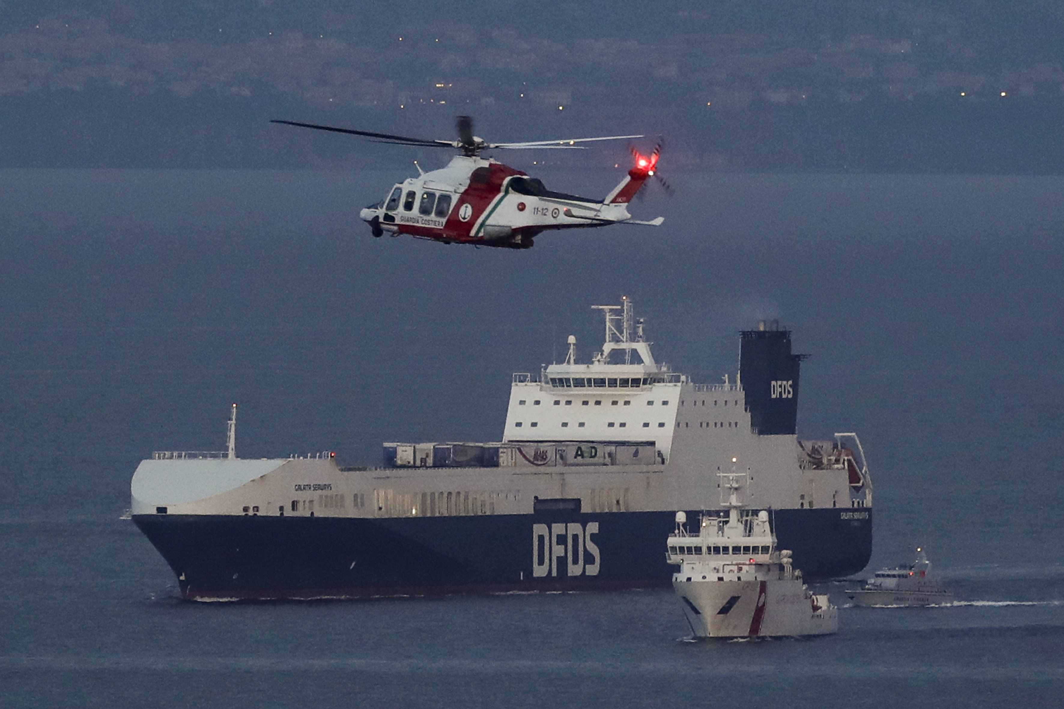 مروحية وسفينة تابعة لخفر السواحل الإيطالي ترافق نقل سفينة الشحن التركية التي خطفها بعض المهاجرين الى نابولي.