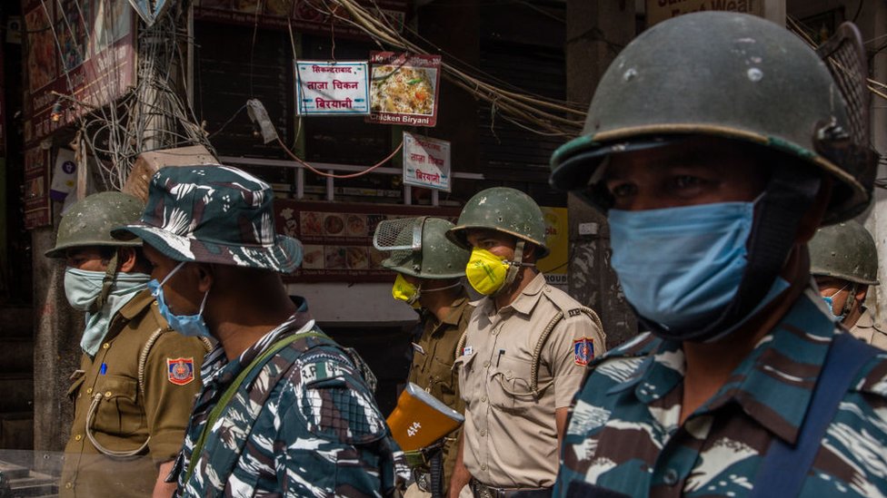 Image shows Indian policemen wearing protective masks