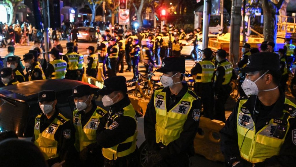 Police officers block Wulumuqi street, named for Urumqi in Mandarin, in Shanghai on November 27, 2022, in the area where protests against China's zero-Covid policy took place the night before following a deadly fire in Urumqi, the capital of the Xinjiang region.